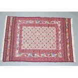 A white, red and green ground Kilim rug with all over geometric design to the centre within a