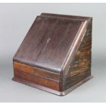 An Edwardian oak wedge shaped stationery box with stepped interior, the base fitted a drawer 33cm