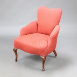 An Edwardian shaped nursing chair upholstered in red material raised on cabriole supports 80cm h x