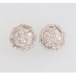 A pair of 9ct white gold circular tapered baguette and brilliant cut diamond ear studs, 3.2 grams,