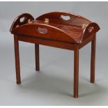A Georgian style mahogany oval butler's tray coffee table raised on square tapered supports with