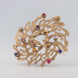 A 14ct yellow gold gem set open freeform brooch with diamonds, rubies and sapphires 45mm, 13.3 grams