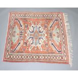 A Caucasian style tan, white and green rug with central medallion and multi row border 149cm x 133cm