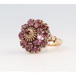 An 18ct yellow gold garnet cluster target ring 7.3 grams, size N 1/2