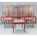 A set of 7 1930's Queen Anne style mahogany stick and rail back dining chairs with upholstered
