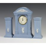 A Wedgwood blue Jasperware timepiece 22cm together with a pair of square candlesticks 15cm