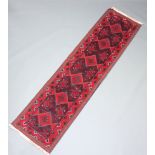 A red and blue ground Meshwani runner with 6 diamonds to the centre 262cm x 96cm