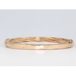 A 9ct yellow gold twist bangle 7.9 grams, 5.5cm diam.