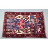 A blue and red ground Belouche rug decorated buildings 150cm x 95cm