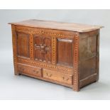 A 17th/18th Century oak mule chest of panelled construction with hinged lid, the base fitted 2