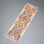 An orange, green and white ground Chobi Kilim runner with 4 diamonds to the centre 200cm x 66cm