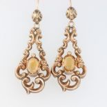 A pair of Victorian yellow metal scroll earrings set with oval citrines, 5 grams, 55mm Both earrings