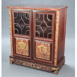 A Chinese carved hardwood cabinet, fitted shelves enclosed by a pair of astragal glazed panelled