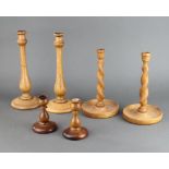 A pair of Art Deco turned oak candlesticks 31cm h, a pair of spiral turned ditto 25cm h and a pair