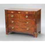 A Georgian inlaid mahogany bow front chest of 2 short and 2 long drawers with brass drop handles,