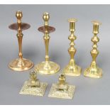 A pair of 19th Century brass candlesticks of squat square form, 8cm h x 10cm x 10cm, 1 other pair