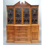 A Georgian style mahogany breakfront library bookcase with shaped cornice, fitted cupboards enclosed