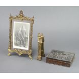 A gilt metal easel photograph frame 24cm h x 13cm (hinge f), a pair of brass nutcrackers in the form