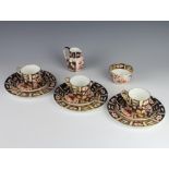 Three Royal Crown Derby Imari pattern trios together with a milk jug and sugar bowl