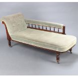 A late Victorian mahogany show frame chaise longue upholstered in green buttoned material with