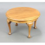 A circular light oak Queen Anne style coffee table, raised on cabriole supports 36cm h x 60cm