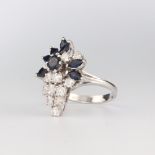 A white metal stamped 18ct sapphire and diamond cocktail ring with 12 brilliant cut diamonds approx.