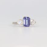 A white metal stamped plat. tanzanite and diamond ring, the emerald cut centre stone 1.7ct, the 2