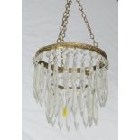 A circular gilt metal light fitting hung lozenges 16cm x 16cm, (some lozenges missing)