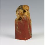 A late 19th Century carved soapstone seal in the form of a She She with pup on her back 11cm Minor