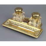 A Victorian brass and glass 2 bottle ink stand with 2 cut glass bottles, nib wipe and pen receptacle