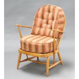 Mid Century, an "Ercol" elm and beech hoop back open armchair 80cm h x 63cm w x 46cm d (seat 39cm