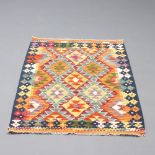 A turquoise, orange and green ground Chobi rug with all over geometric designs 126cm x 83cm