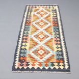 A black, yellow and blue ground Chobi Kilim runner with 4 diamonds to the centre 190cm x 64cm