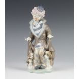 A Lladro figure of a clown with dogs at his feet 5901 24cm