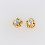 A pair of yellow metal twist mount earring, each set with a brilliant cut diamond approx. 0.5ct, SI2