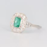 A white metal stamped plat emerald and diamond Art Deco style ring, the emerald 0.7ct, the brilliant