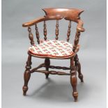 A 19th Century elm smokers bow chair raised on turned supports with H framed stretcher, the back