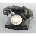 A black Bakelite dial telephone, the base marked F/232F FWR 55/2