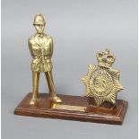 A Metropolitan Police brass presentation set comprising a facsimile helmet plate and standing police