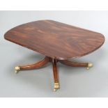 A Georgian style mahogany coffee table, raised on a turned column and tripod base ending in brass