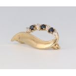 A 9ct yellow gold diamond and sapphire scroll brooch 2.4 grams, 28mm