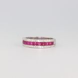 A white metal stamped 750 Art Deco style ruby and diamond cocktail ring with 11 princess cut