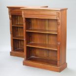 A pair of Victorian style hardwood open bookcases with adjustable shelves, the upper sections fitted