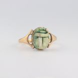 A yellow metal stamped 18ct scarab ring, size S 1/2, 3.6 grams