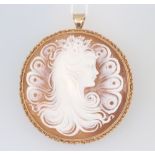 A good Victorian circular carved cameo brooch/pendant in the form of a young lady with flowers in