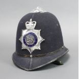 An Elizabeth II Metropolitan Police helmet complete with chin strap Image of interior added.