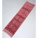 A red and blue ground Meshwani runner with 17 diamonds to the centre 250cm x 64cm