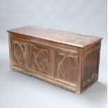 A 17th/18th Century oak coffer of panelled construction with original loop hinges and iron lock, the