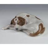 A Royal Copenhagen figure of a reclining hound with original label, 20cm This lot is in good