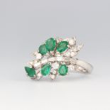 A white metal stamped 18k emerald and diamond cocktail ring, the 6 pear cut emeralds approx. 1.5ct
